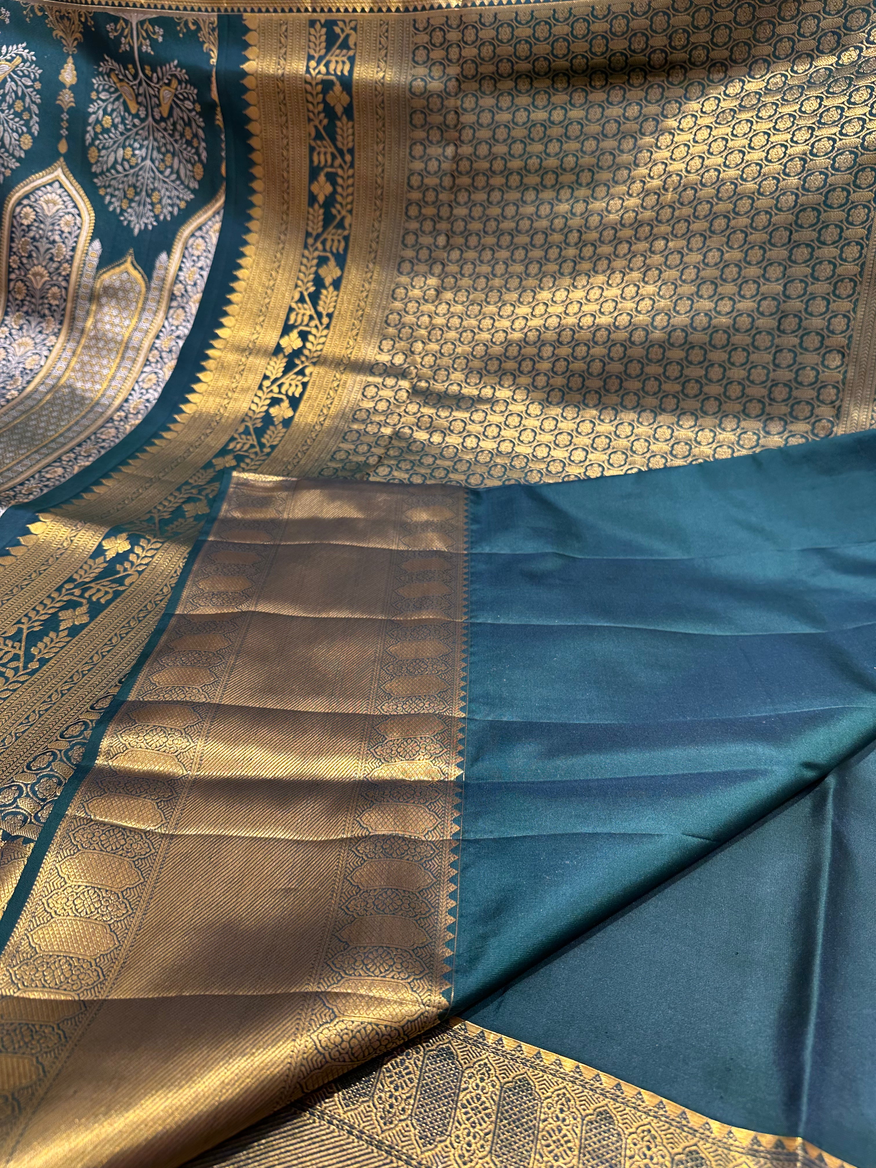 Dark Green Pure Kanjivaram Silk Saree with Silver and Gold Zari Designs. Rich Gold Zari Border adds a Grand Traditional Look.