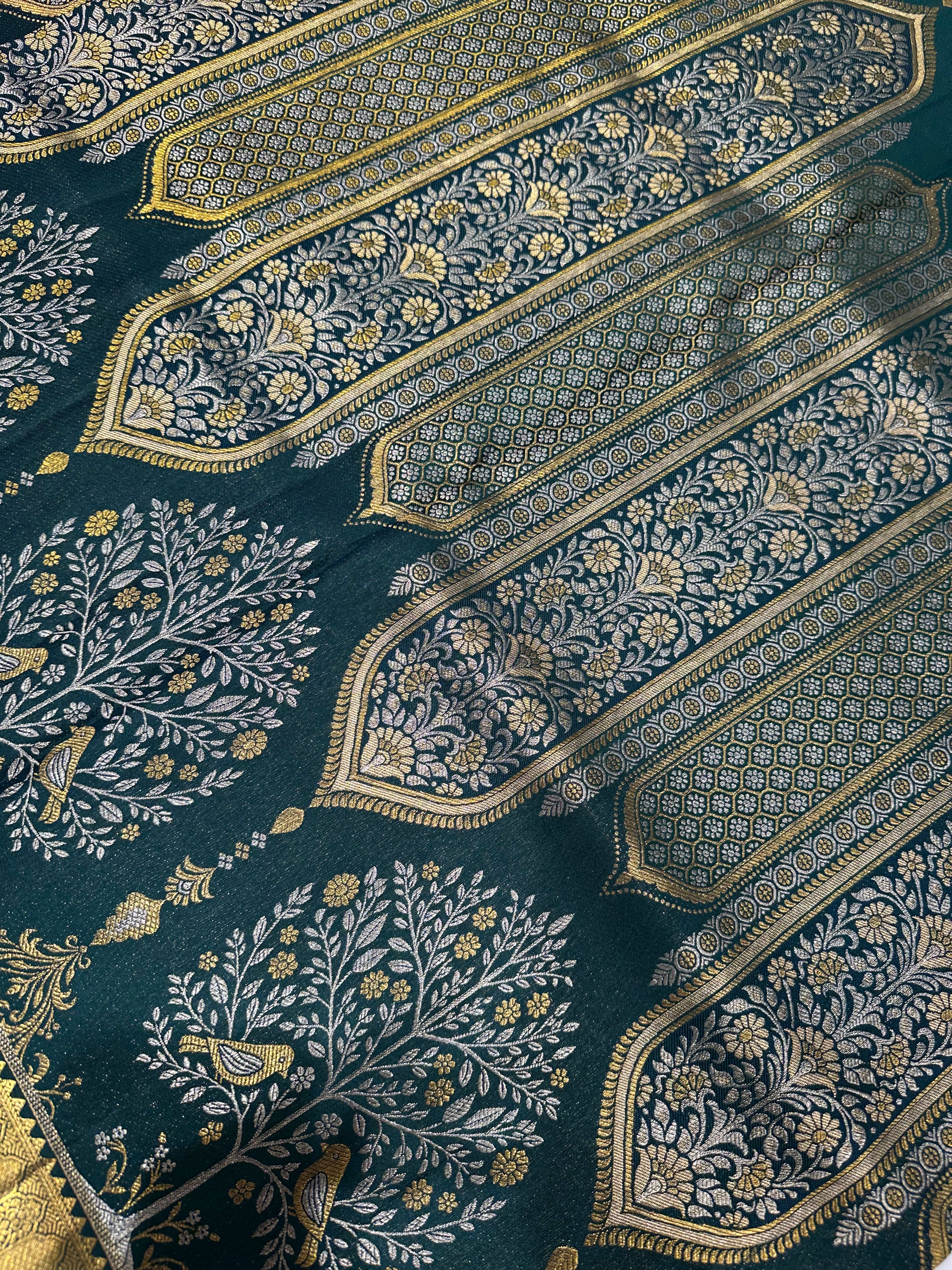 Dark Green Pure Kanjivaram Silk Saree with Silver and Gold Zari Designs. Rich Gold Zari Border adds a Grand Traditional Look.