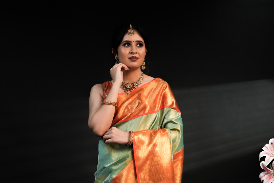 Pista Green Pure Kanjivaram Silk Saree with Rich Orange Border and Dual Tone Yali Zari Design