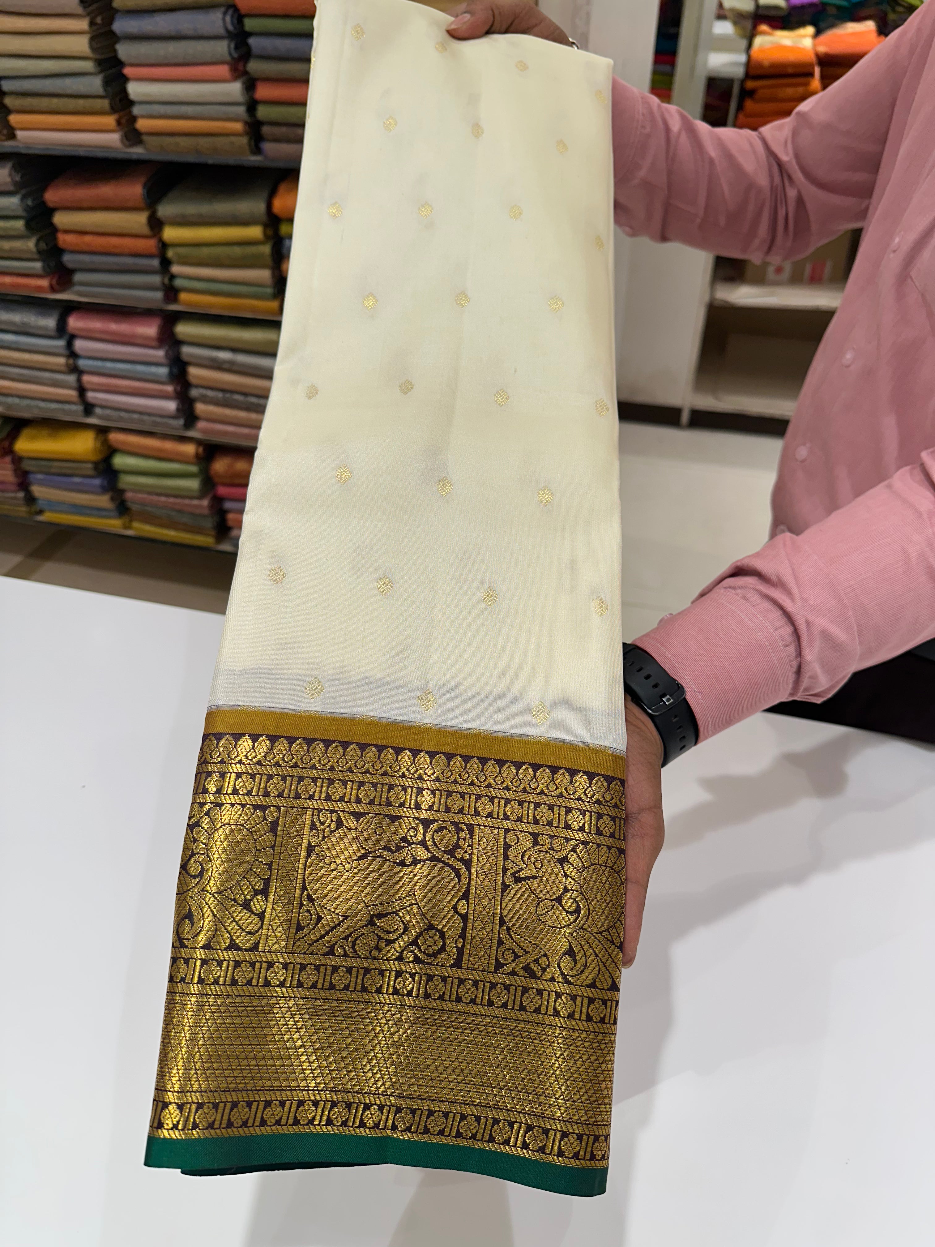 Golden Heritage White–Green Leela Verse Saree with Rich Zari Buttas & Border