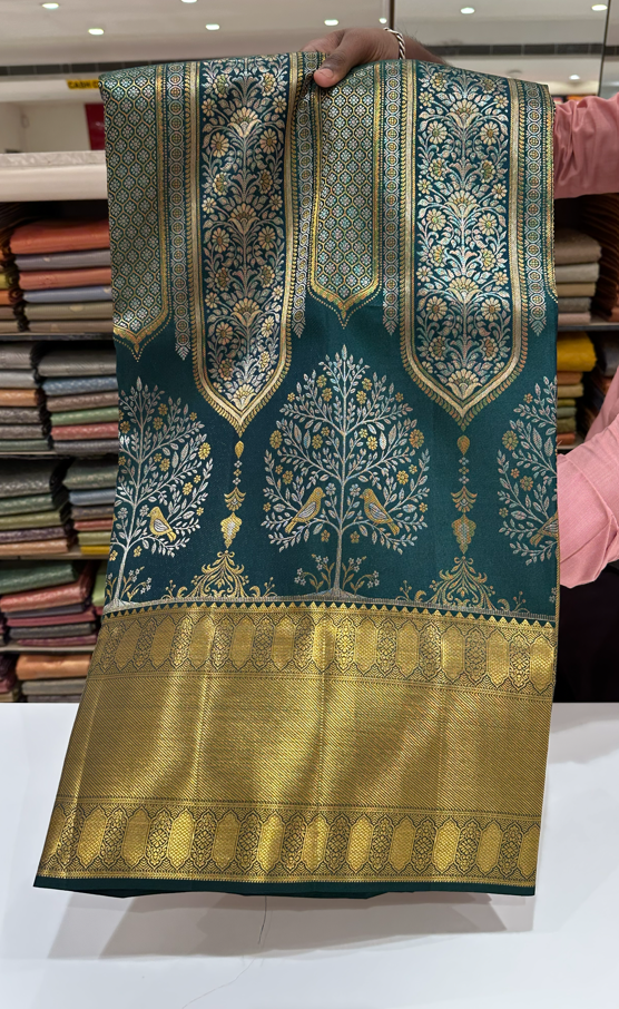 Dark Green Pure Kanjivaram Silk Saree with Silver and Gold Zari Designs. Rich Gold Zari Border adds a Grand Traditional Look.