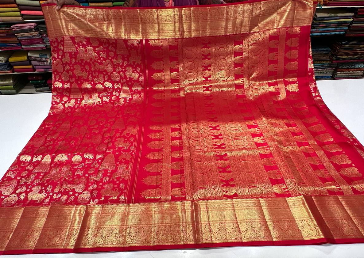 Red color Kanjivaram saree with full gold zari butta and border, perfect for bridal and wedding events.
