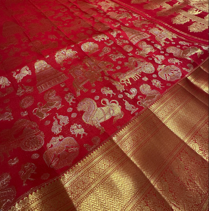 Red color Kanjivaram saree with full gold zari butta and border, perfect for bridal and wedding events.
